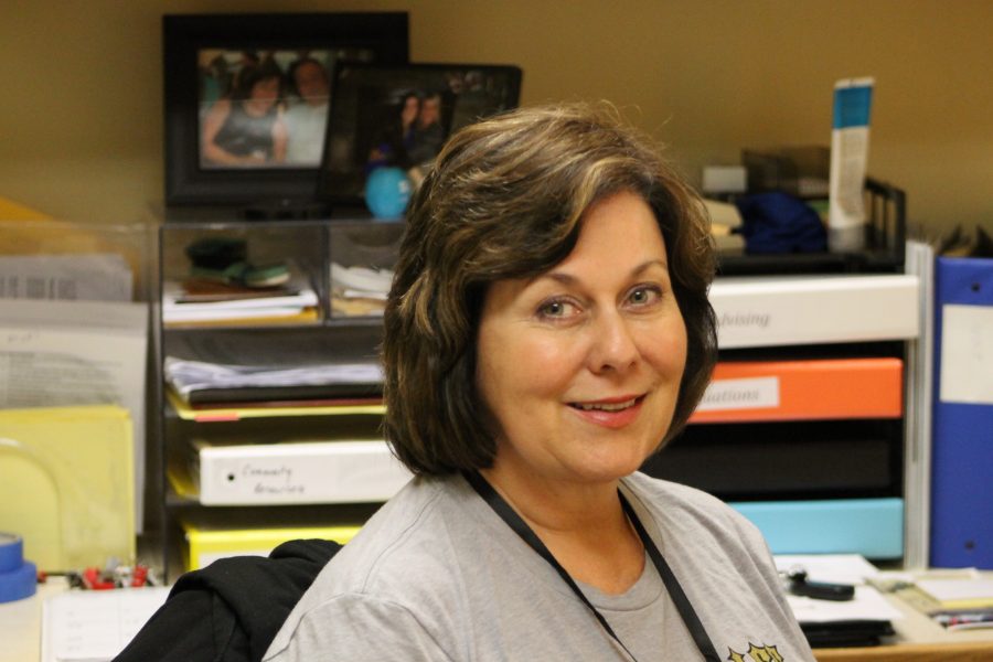 Kim Glathar smiles inside her office in the counseling center. 