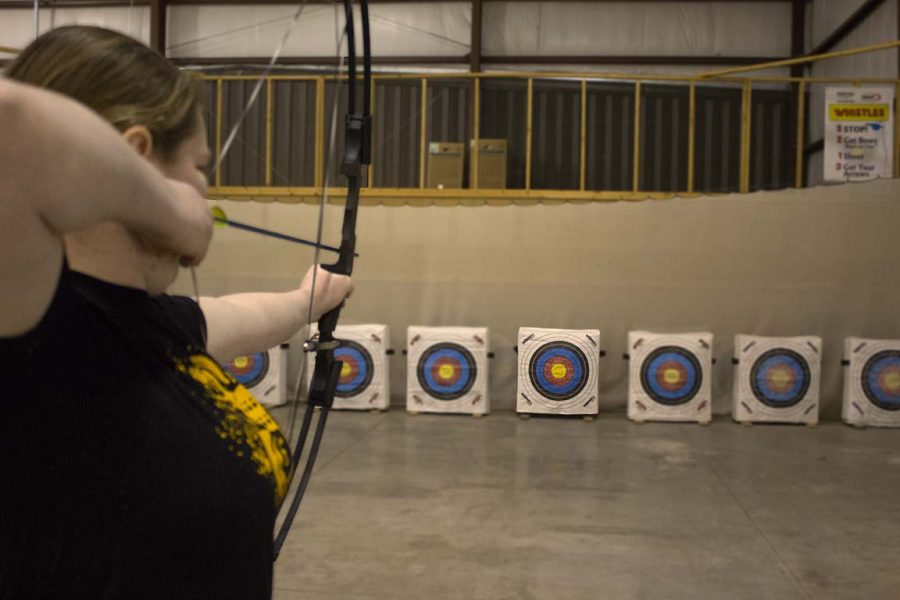 Senior Paige Trevarrow aims at her target during practice.