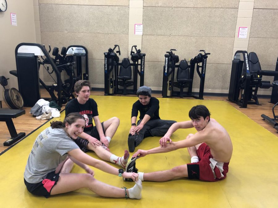 From left to right, Abby Cawley (12), Lewis Reimer (10), Lorenzo Silverio (10), and Lane Nollendorfs-Miller (12) stretch after a chilling run. 
