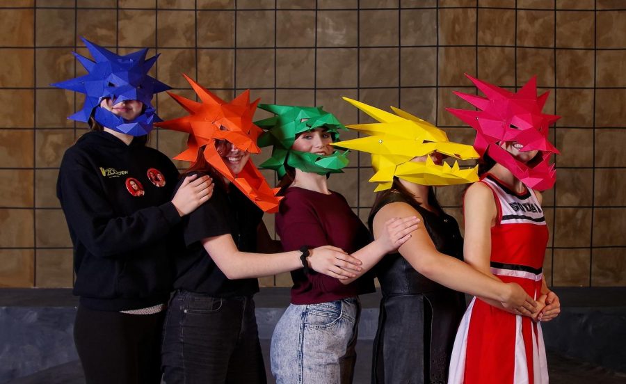 Cast members from the Fall Play She Kills Monsters pose with the paper dragon heads made by Lisle Gustafson. These props, along with the fish Gustafson made for last years musical, garnered her the Nebraska Young Artist Award for Theatre Arts (Prop-Making). 
Photo Credit: Steve Cobb
