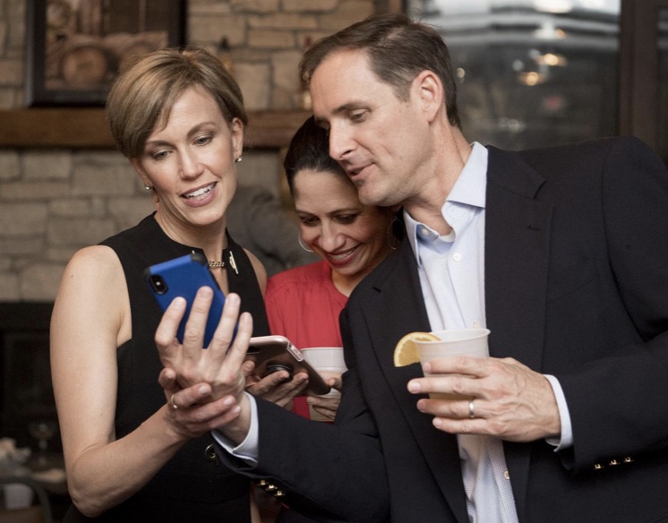 Mayor-elect Leirion Gaylor Baird (left) looks over final vote with her husband Scott Baird (right) and long-time family friend Jackie Ostrowicki on Tuesday, May 7.