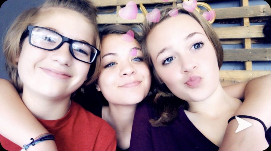 Freshman Stasia Garrison taking a group selfie with her brother and her friend, Kylie Thiessen (9), while spending time with them over the summer. 
