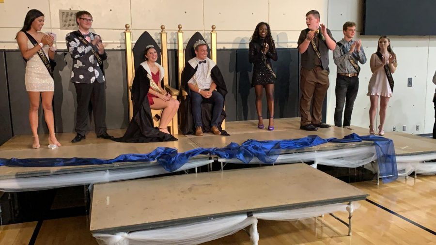 Seniors Reis Jensen and Sadie Prenda sit on their thrones at Homecoming after being crowned king and queen.