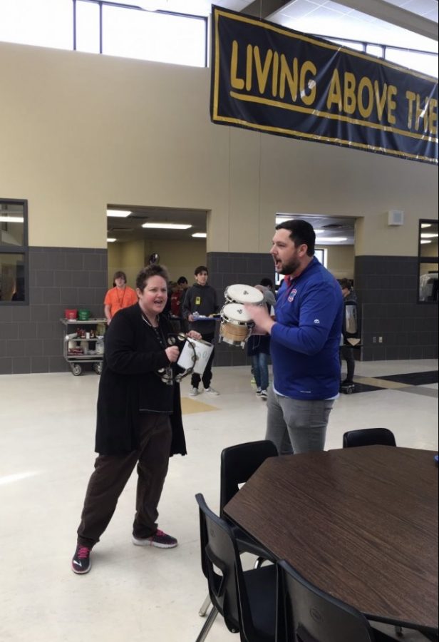 English teacher Julie Krueger and Music teacher Sam Rickert raise awareness for the Food Drive through a musical performance at all three lunches.