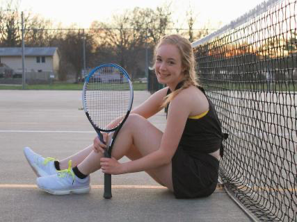 Senior Rachel Odabasi posing on a tennis court.