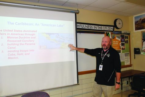 Jesse Reynolds gestures at the board as he teaches his AP World History class. Photo cred: Maren Steinke