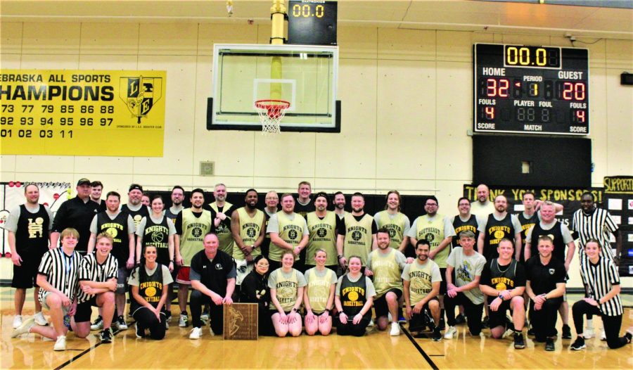 Both staff teams, referees and announcer pose for phtoto after the staff game. 
Photo Credit: Maya Ward