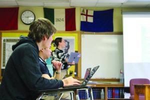 Students in Sasha Hoxie's GoPo class taking notes during a lecture.