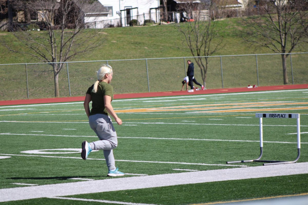 Fiona Thorne (9) running hurdles at practice.