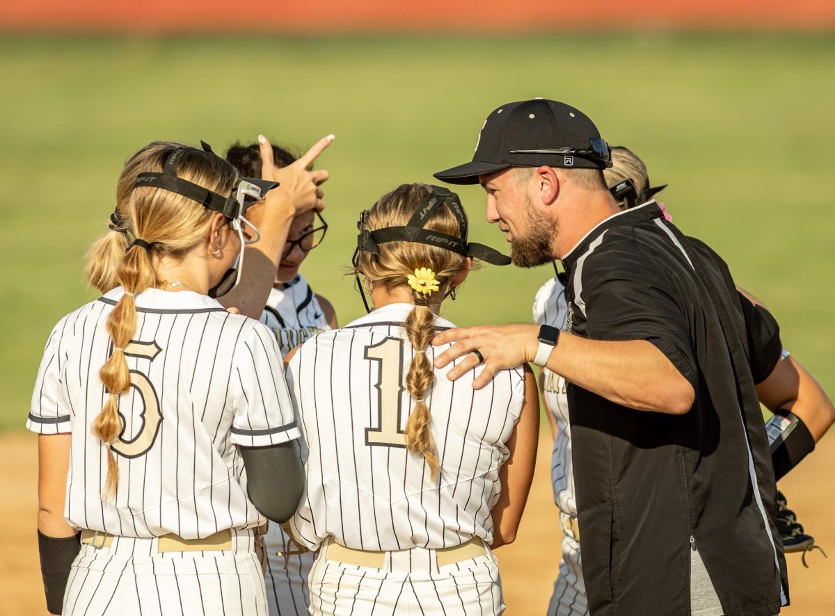 Kuesel huddles with the team 