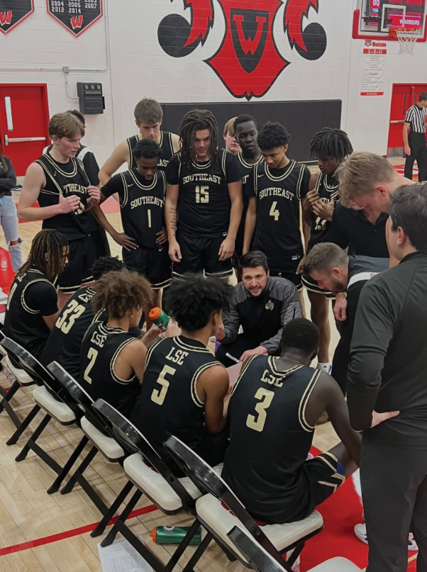 Joseph Werning coaches LSE boys basketball on the sideline against Omach Westside. 
Photo Courtesy: (@LSEAthletics) / X 