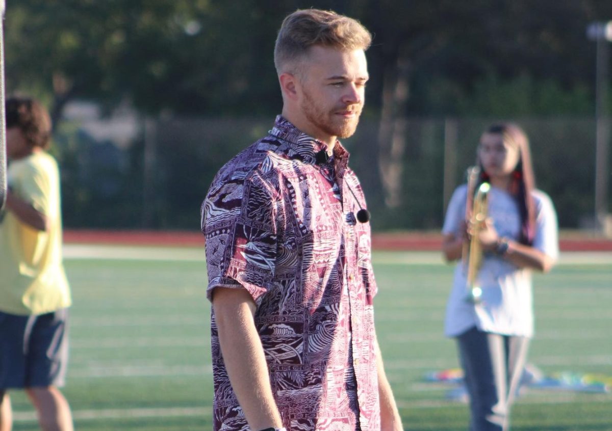 Seth Burk watches the band marching during morning practice