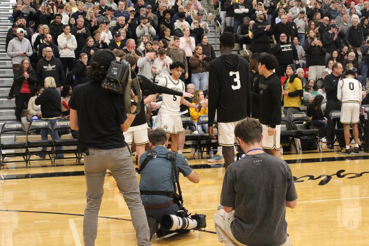 Media personnel cover LSE Boys Basketball’s starting five before the LSW vs. LSE game tip off.
